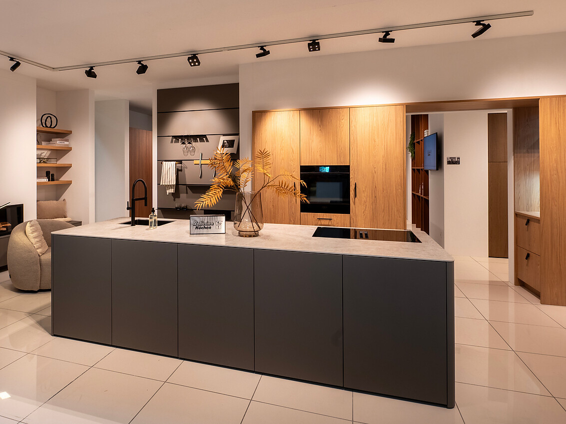 Een eilandkeuken die gezelligheid en modern design combineert. Met lichte houtfronten straalt hij warmte en stijl uit. Hoogwaardige apparatuur zorgt voor een duurzame en praktische keukenervaring. Zuordnung: Stil Moderne keukens, Planungsart Keuken met keukeneiland